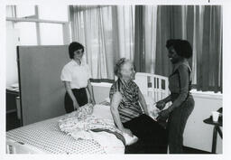 [Homemaker Training Program students assisting client]